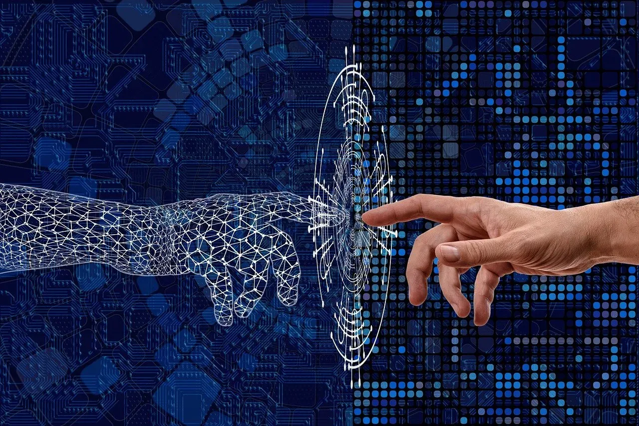 Mano humana y mano digital de inteligencia artificial a punto de tocarse: la IA aplicada a la dirección de empresas